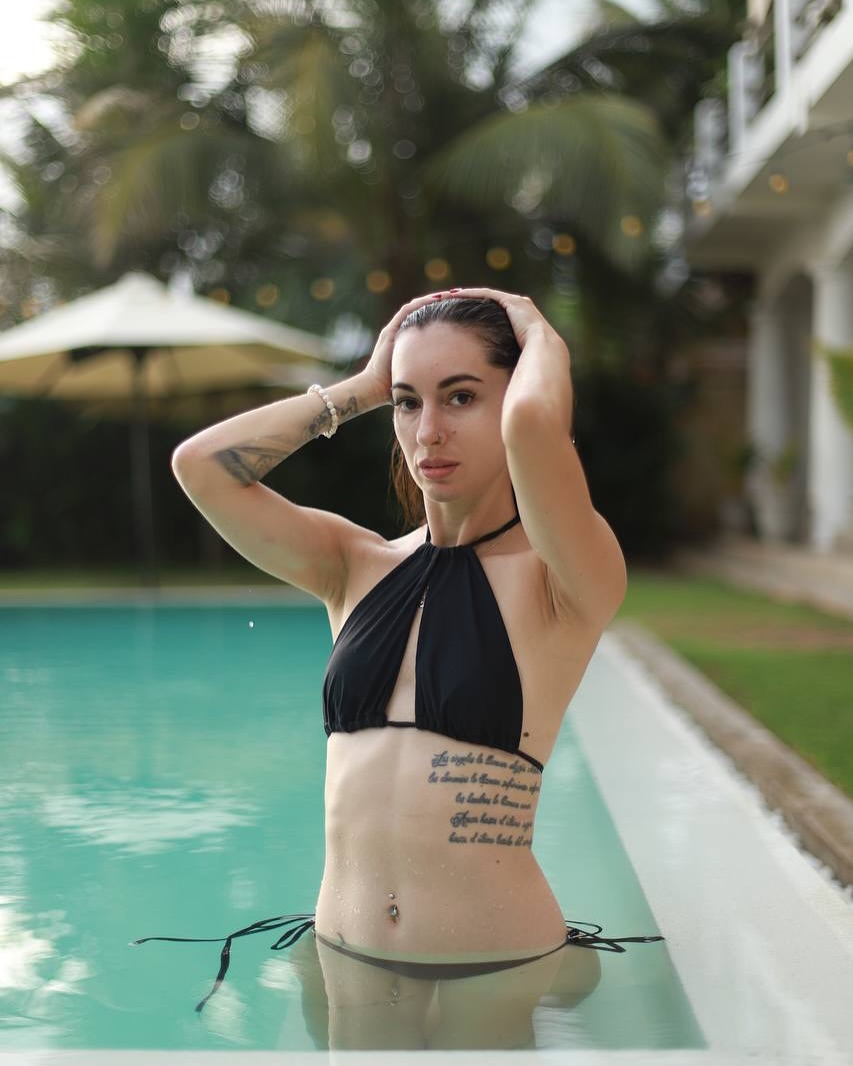Model in a black Brandis Boutique bikini by the pool